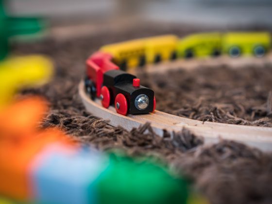 Colourful wooden toy train on the carpet in the living room in the house